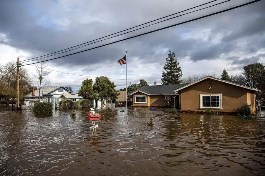 Winter storm floodwater around homes on a residential street, typical of an East Bay atmospheric river